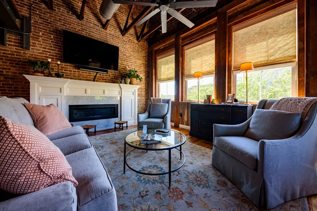Bright, cozy living room decorated with handmade pillows and thrifted furniture